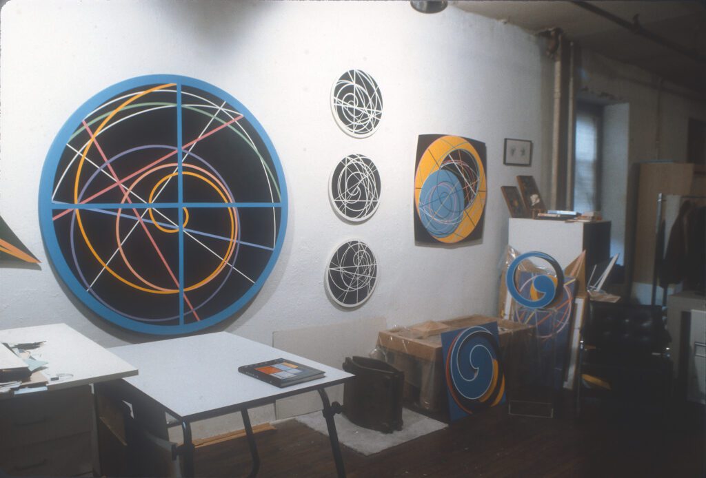 Studio wall with circular abstract geometric paintings