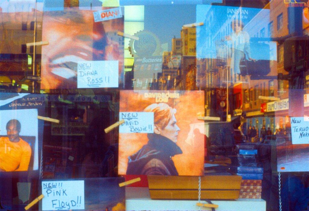 Record store window with album covers, reflections