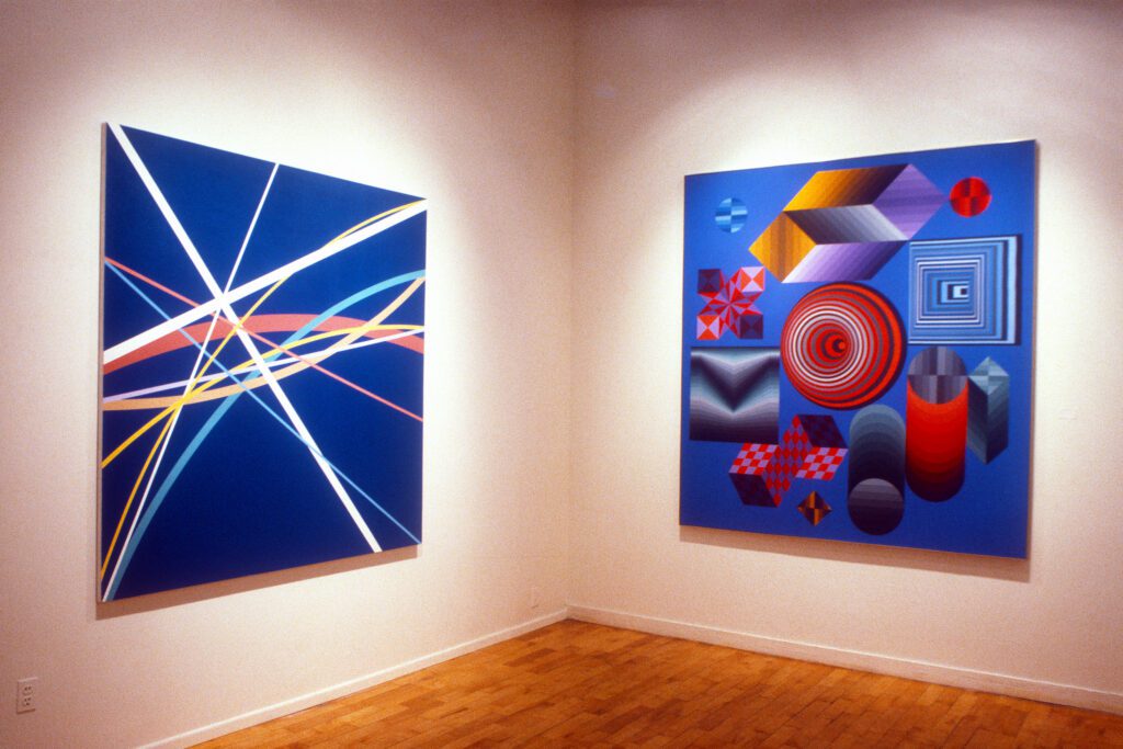 Two abstract blue paintings in gallery corner